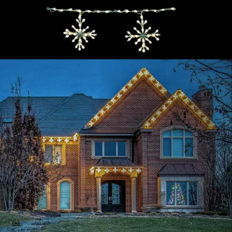 Large Snowflake Outdoor Lights hanging from roof edges on house decorated for the holidays