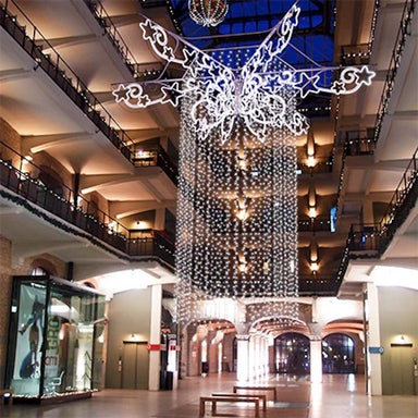 Interior display of pole mount decorations forming a star-like design on the ceiling. 