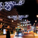 Decorative pole decorations displayed above city street.