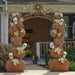 Iron archway for Halloween. Two stacks of pumpkin and skulls on either side of the words "Happy Halloween" arching across the top.