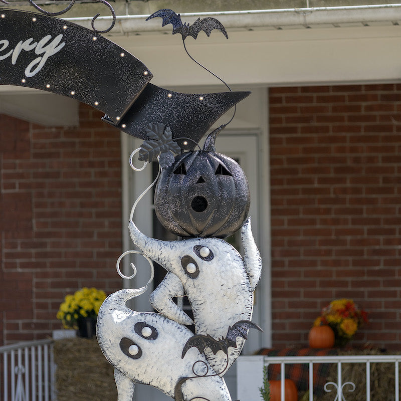 Detailed close up of ghosts, pumpkins and banner on archway for Halloween.