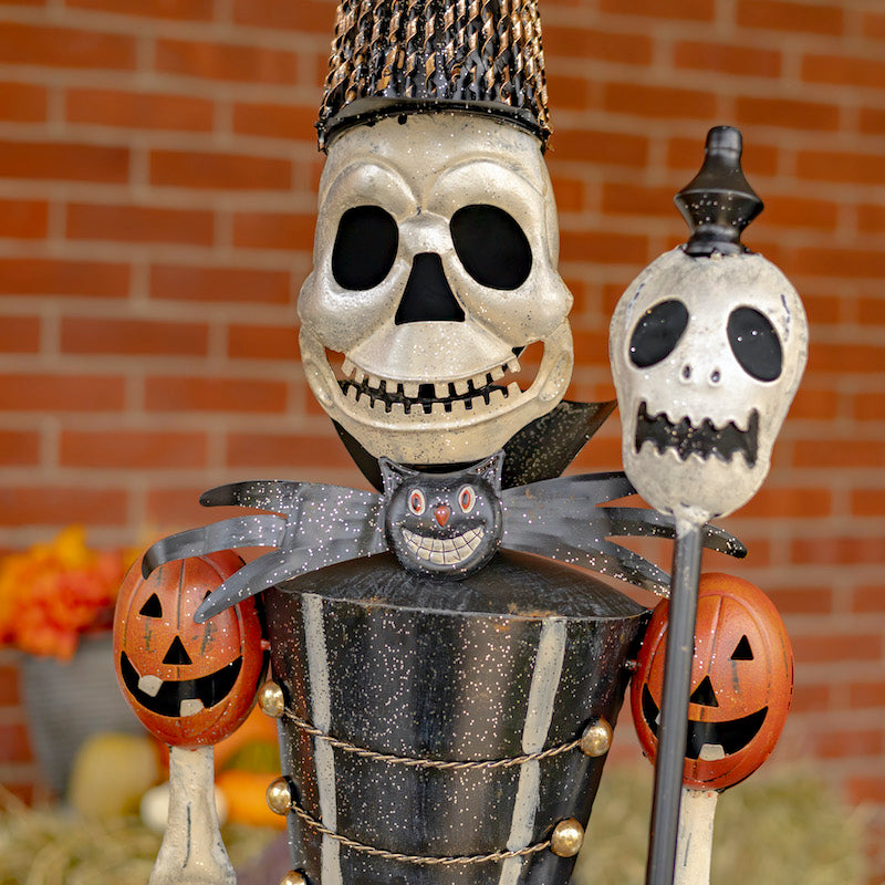 Face closeup of skeleton halloween decoration showing toothy grin and fine painting detail.